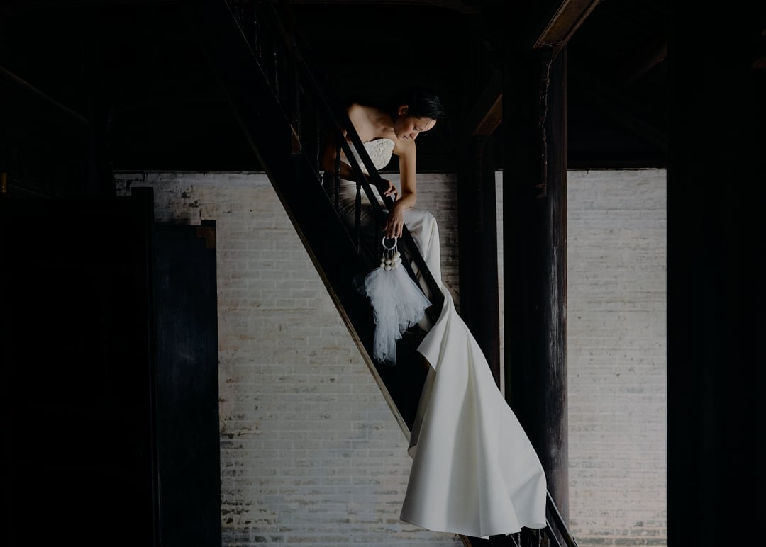 Bride on a dark staircase